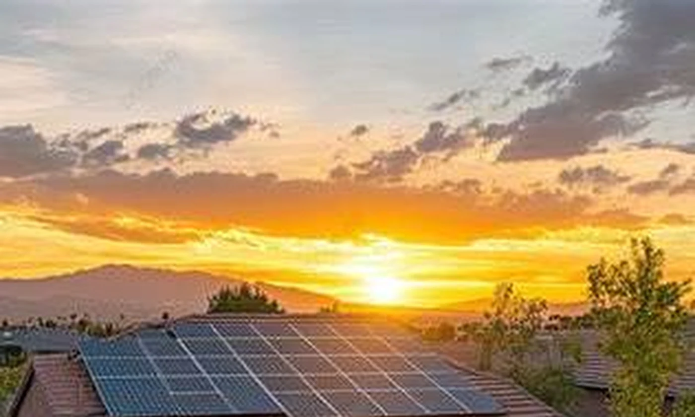 Suburban home with rooftop solar panels at sunset