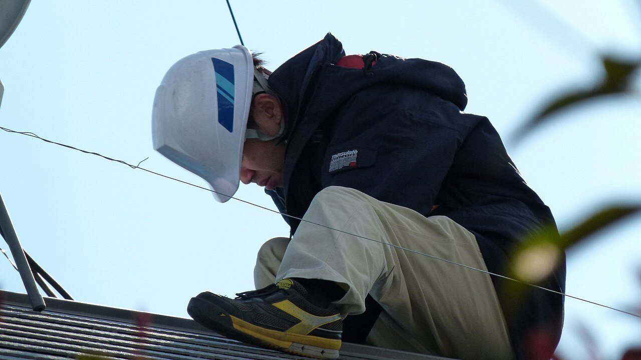 Solar installer working on a roof